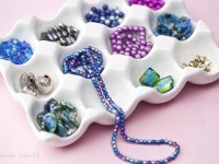Egg tray holding colorful beads