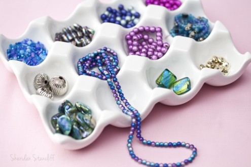 Egg tray holding colorful beads