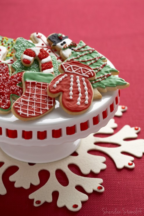 red and green Christmas cookies on a cake stand